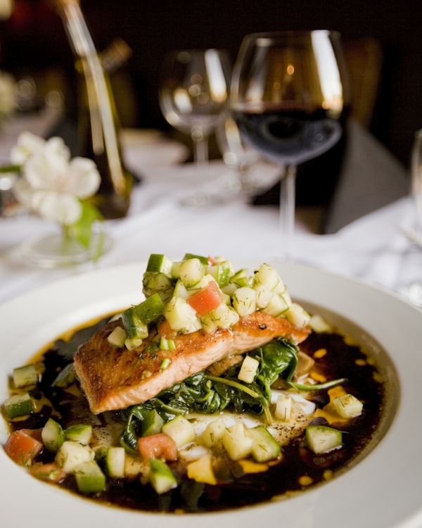 Glazed salmon fillet with herbs in a pan